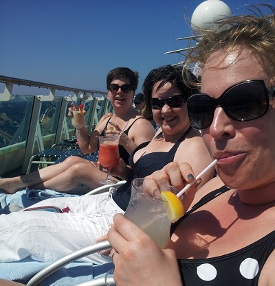 The ladies chillin' on deck with a cocktail