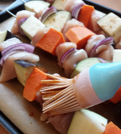 Brushing on the marinade.