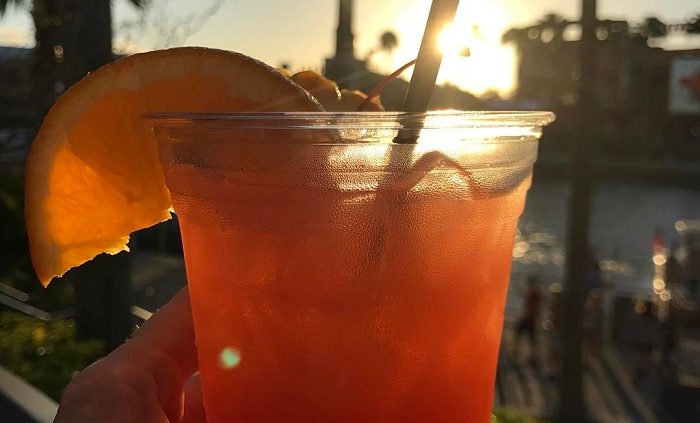 Grabbing a cocktail before Mardi Gras on CityWalk with Toothsome Chocolate Emporium & Savory Feast Kitchen in the background