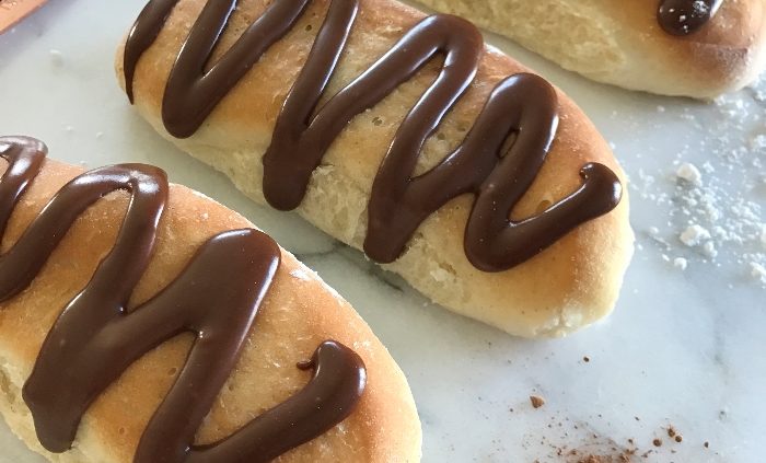 Soft iced buns with chocolate orange drizzle