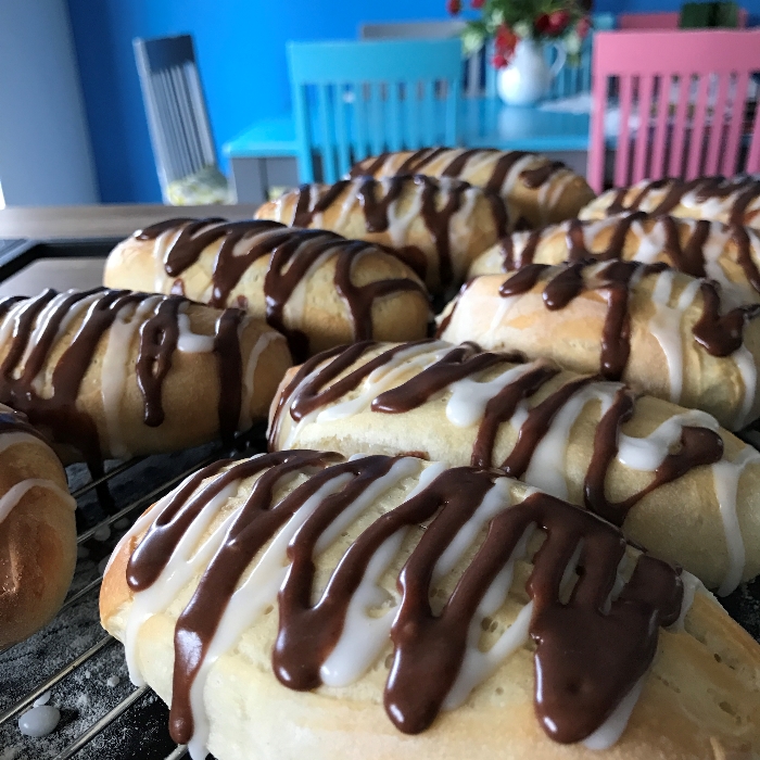 Soft iced buns with plain and chocolate drizzle
