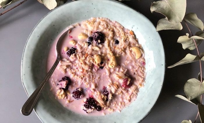 Vanilla, coconut and cashew overnight oats with frozen berries
