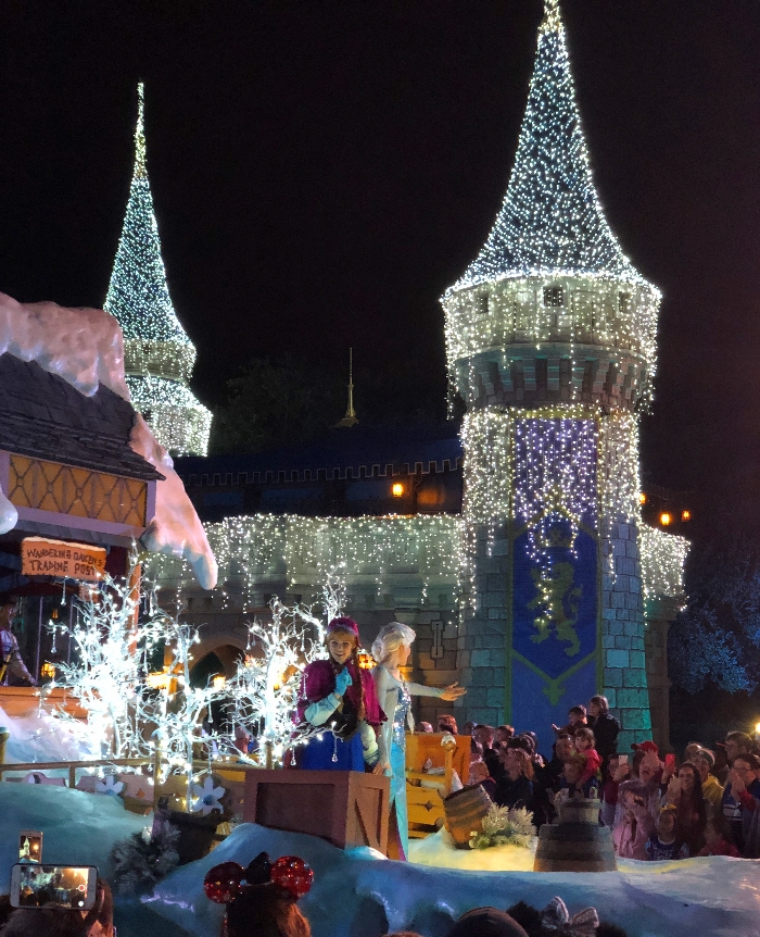 Anna and Elsa on their Mickey's Once Upon a Christmastime parade float