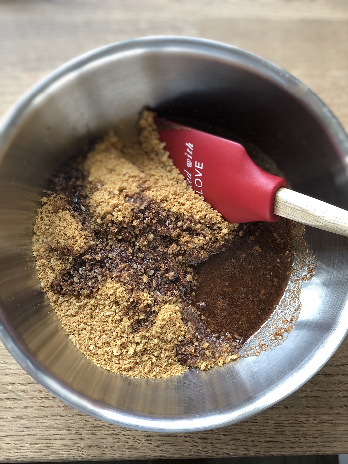Stir the melted butter and Nutella into the biscuit crumbs
