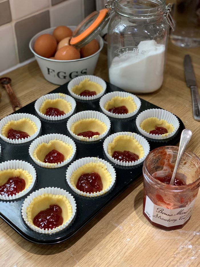 Add a teaspoon of jam to the pastry case