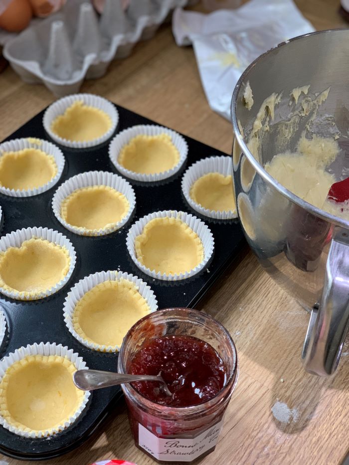 Press the pastry into the paper cases