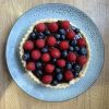 rich chocolate tart with raspberries and blueberries